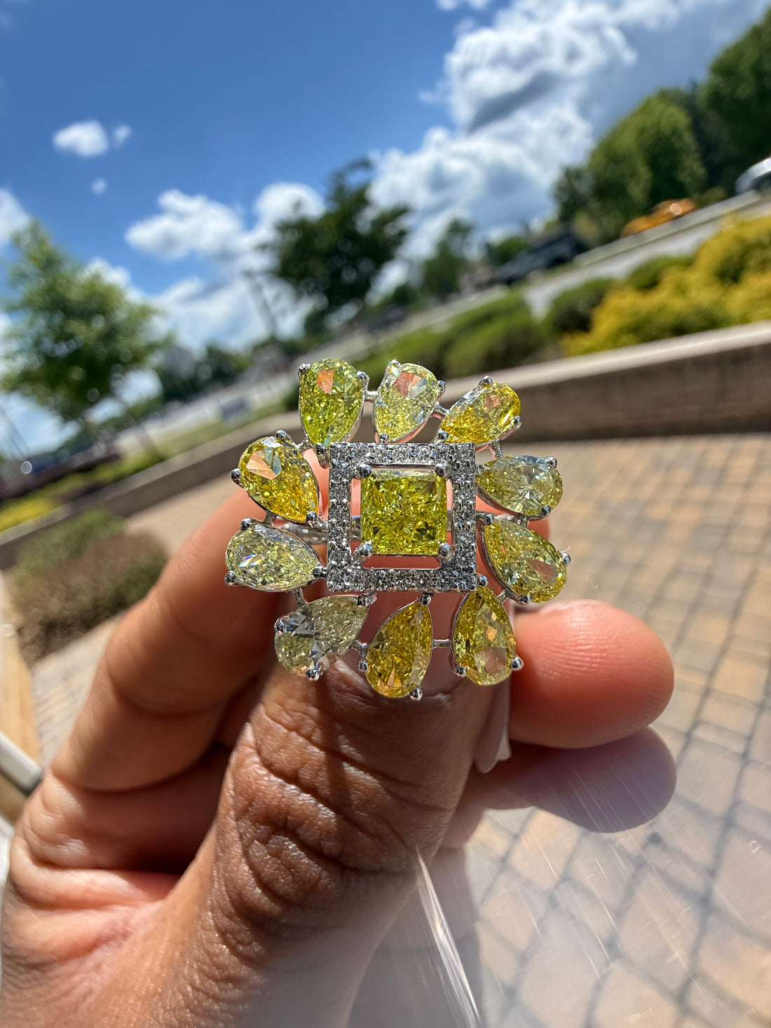 5 carat fancy yellow oval with center princess cut ring in fancy vivid yellow igi certified center stone with special cut side stones on side handcrafted in color high cut with  handcrafted ring made with 14k gold in grown diamond igi certified