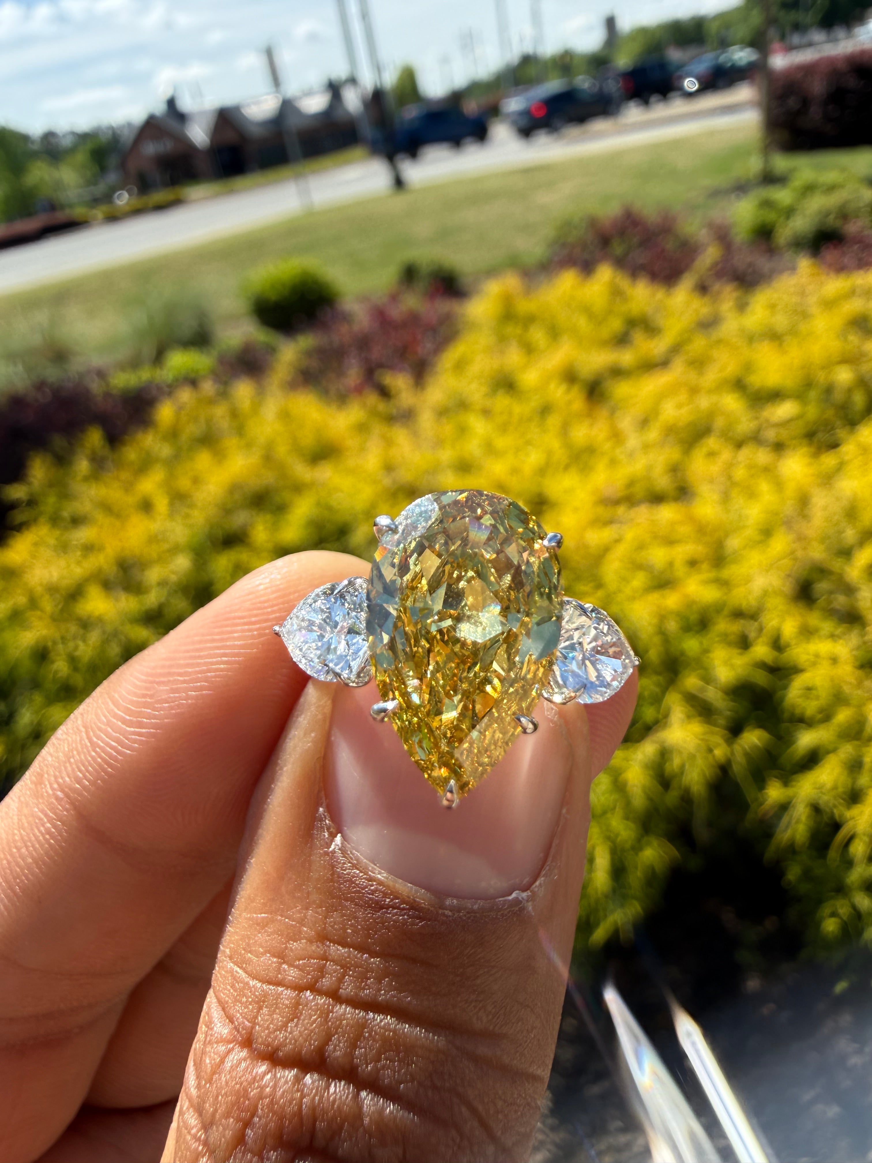 6.5  carat ring with fancy vivid yellow igi certified stone ehandcrafted in color high cut with fancy 2 pear on side stone in  ring handcrafted ring made with 14k gold in grown diamond igi certified