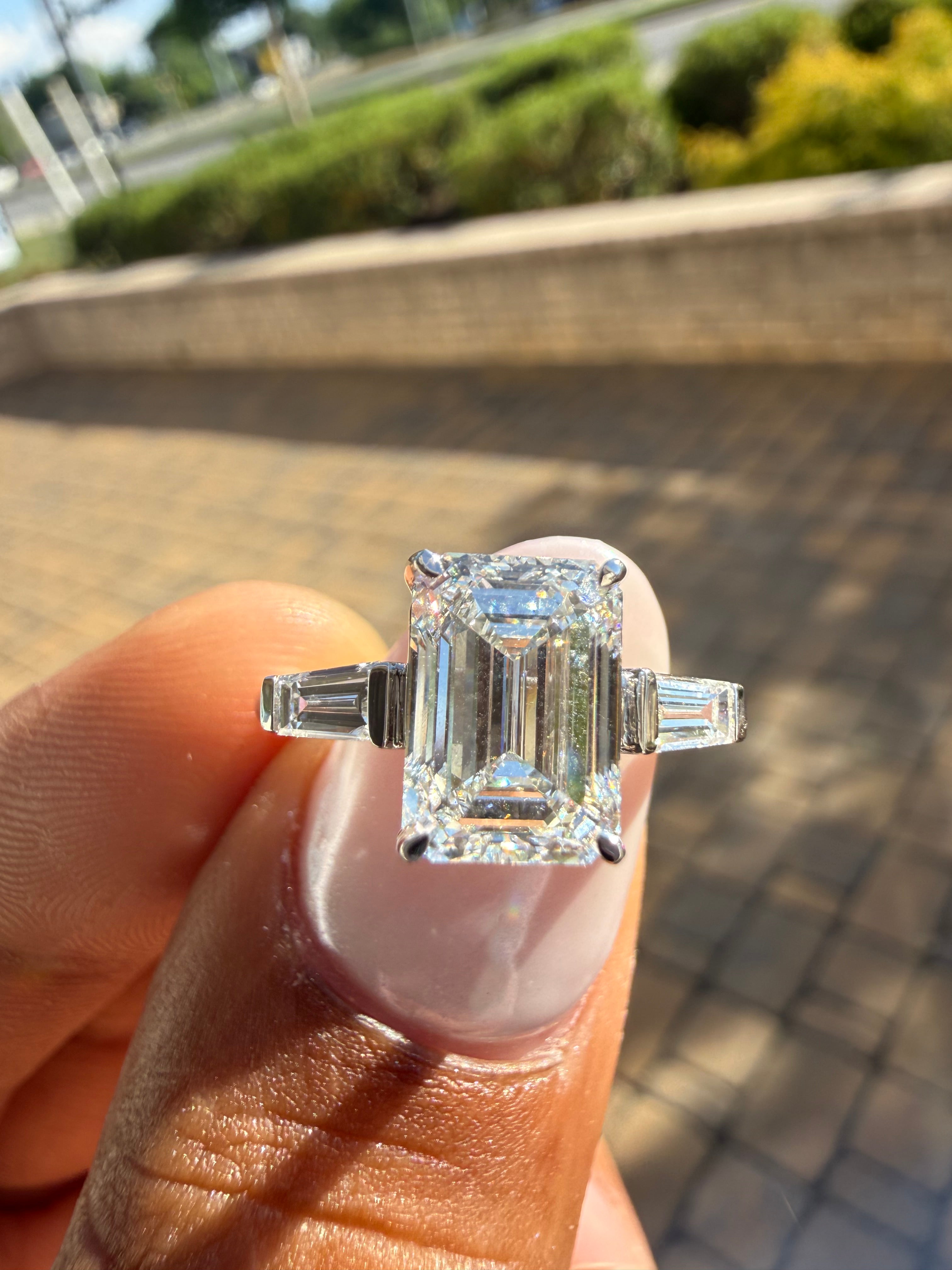 3.75 carat ring emerald cut ring cut E vs IGI certified 3 carat center stone with special cut tapper baguette on side highly handcrafted in grown diamond 14k gold