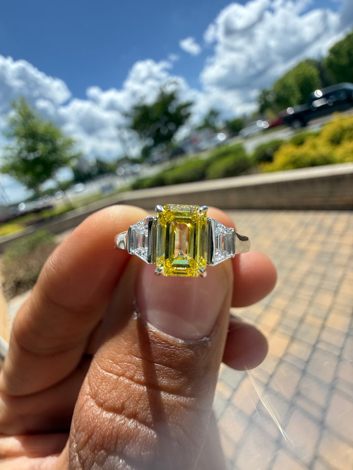 1.5 carat  Emerald cut center stone fancy yellow emerald cut ring in fancy vivid yellow igi certified VS stone with special cut side stones on side handcrafted in color high cut with  handcrafted ring made with 14k gold in grown diamond igi certified