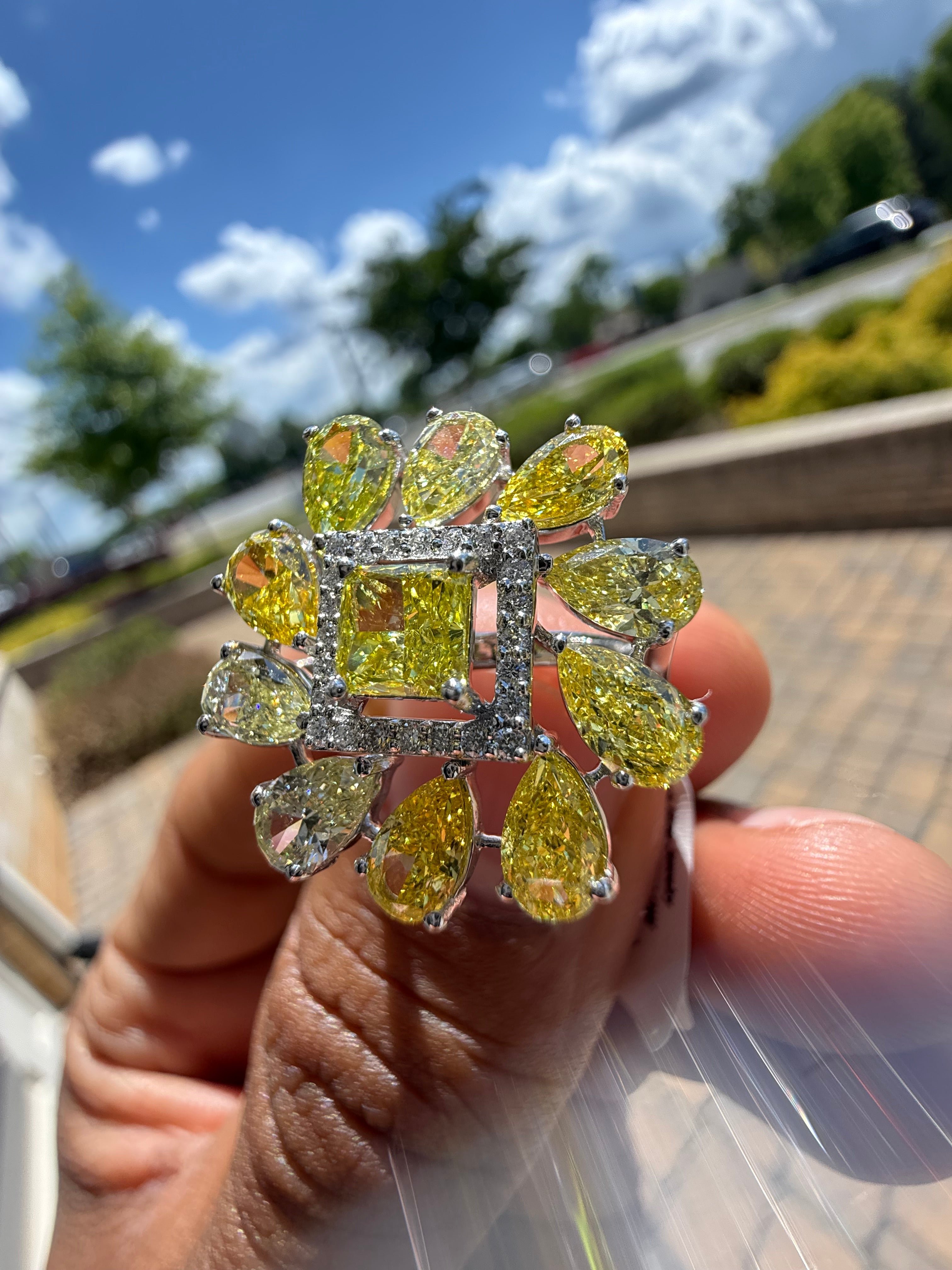 5 carat fancy yellow oval with center princess cut ring in fancy vivid yellow igi certified center stone with special cut side stones on side handcrafted in color high cut with  handcrafted ring made with 14k gold in grown diamond igi certified