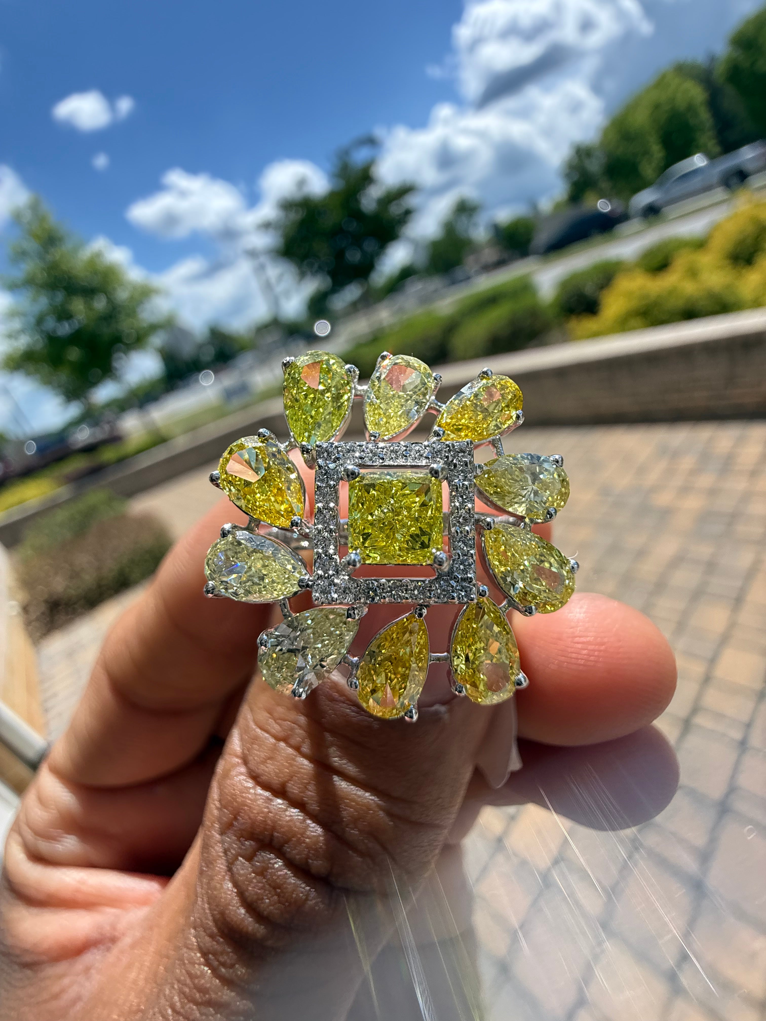 5 carat fancy yellow oval with center princess cut ring in fancy vivid yellow igi certified center stone with special cut side stones on side handcrafted in color high cut with  handcrafted ring made with 14k gold in grown diamond igi certified