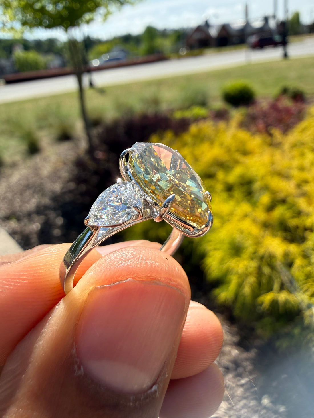 6.5  carat ring with fancy vivid yellow igi certified stone ehandcrafted in color high cut with fancy 2 pear on side stone in  ring handcrafted ring made with 14k gold in grown diamond igi certified