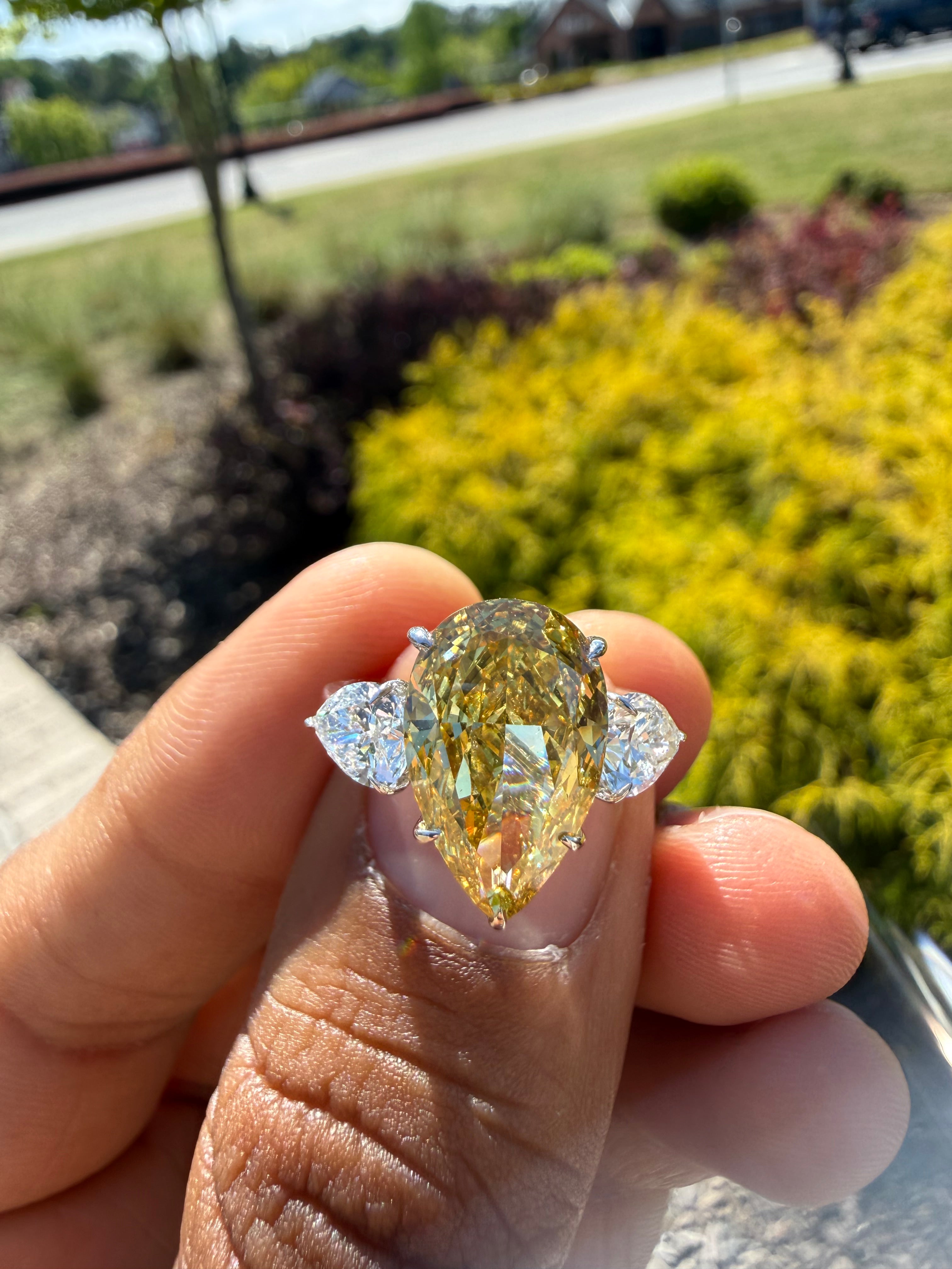 6.5  carat ring with fancy vivid yellow igi certified stone ehandcrafted in color high cut with fancy 2 pear on side stone in  ring handcrafted ring made with 14k gold in grown diamond igi certified