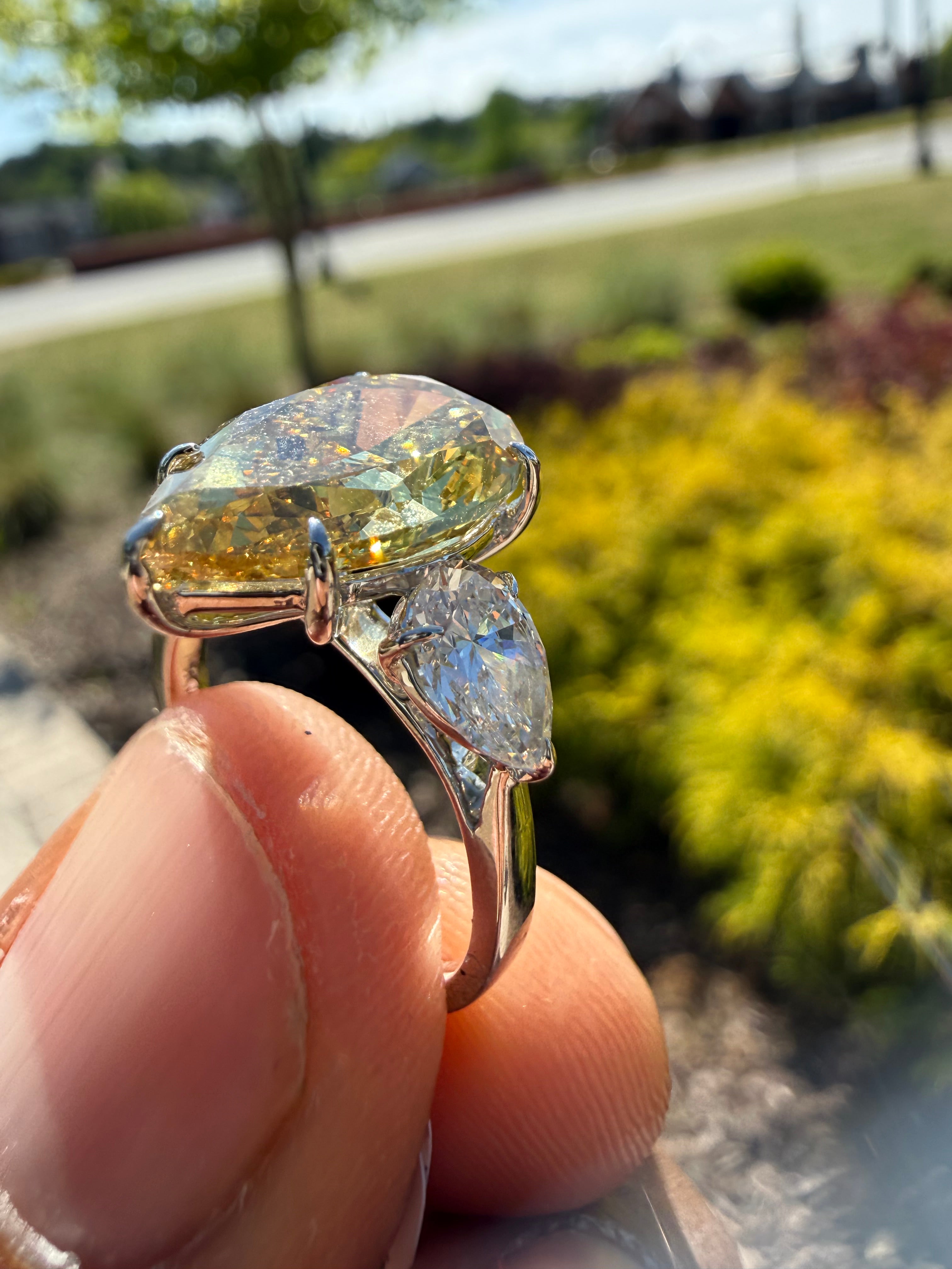 6.5  carat ring with fancy vivid yellow igi certified stone ehandcrafted in color high cut with fancy 2 pear on side stone in  ring handcrafted ring made with 14k gold in grown diamond igi certified