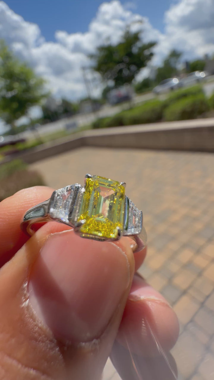 1.5 carat  Emerald cut center stone fancy yellow emerald cut ring in fancy vivid yellow igi certified VS stone with special cut side stones on side handcrafted in color high cut with  handcrafted ring made with 14k gold in grown diamond igi certified