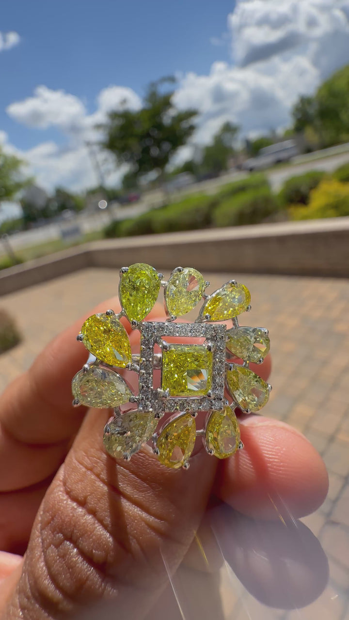 5 carat fancy yellow oval with center princess cut ring in fancy vivid yellow igi certified center stone with special cut side stones on side handcrafted in color high cut with  handcrafted ring made with 14k gold in grown diamond igi certified